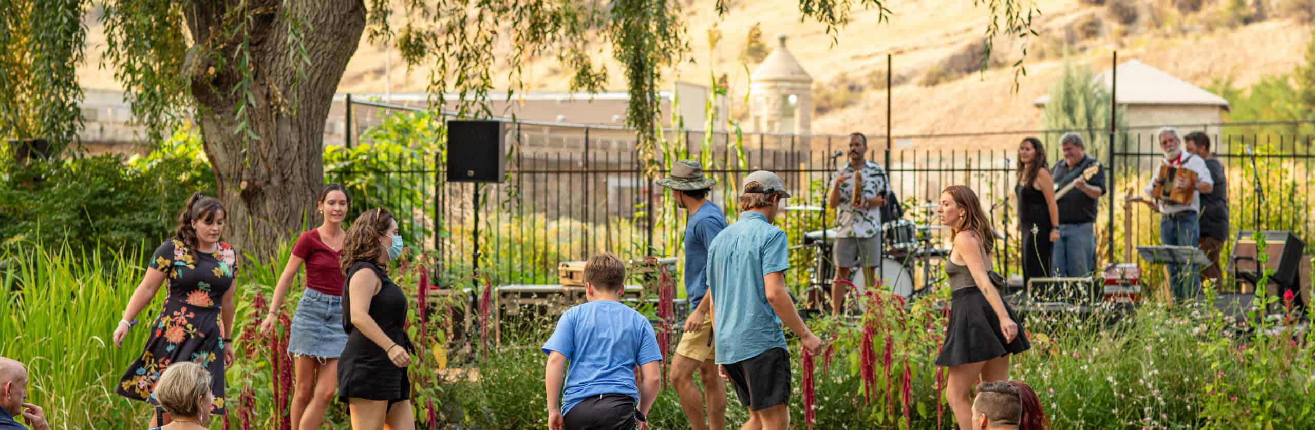 A group of people dancing as a band plays in the background.