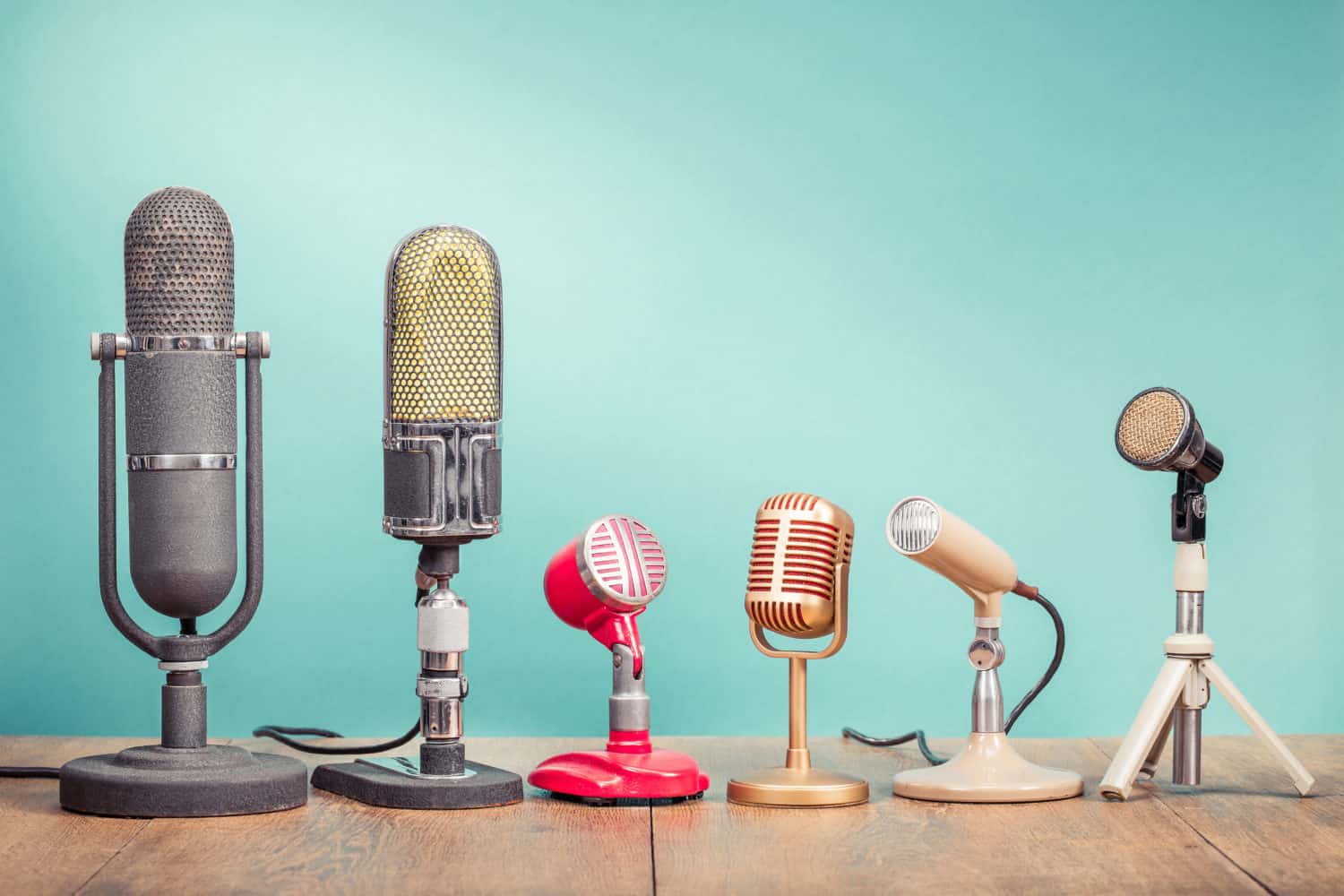 A row of microphones on a blue background