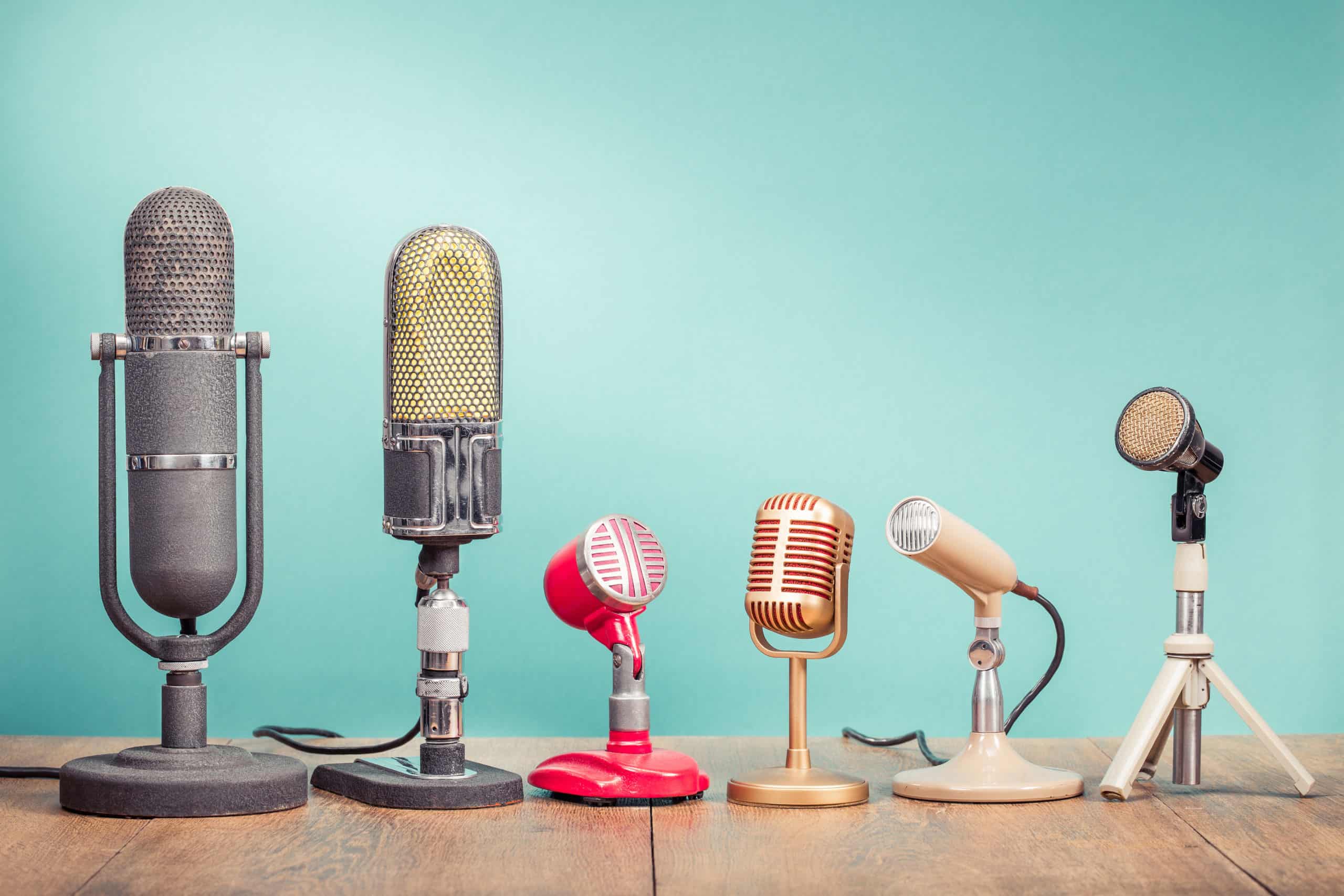 A row of microphones on a blue background