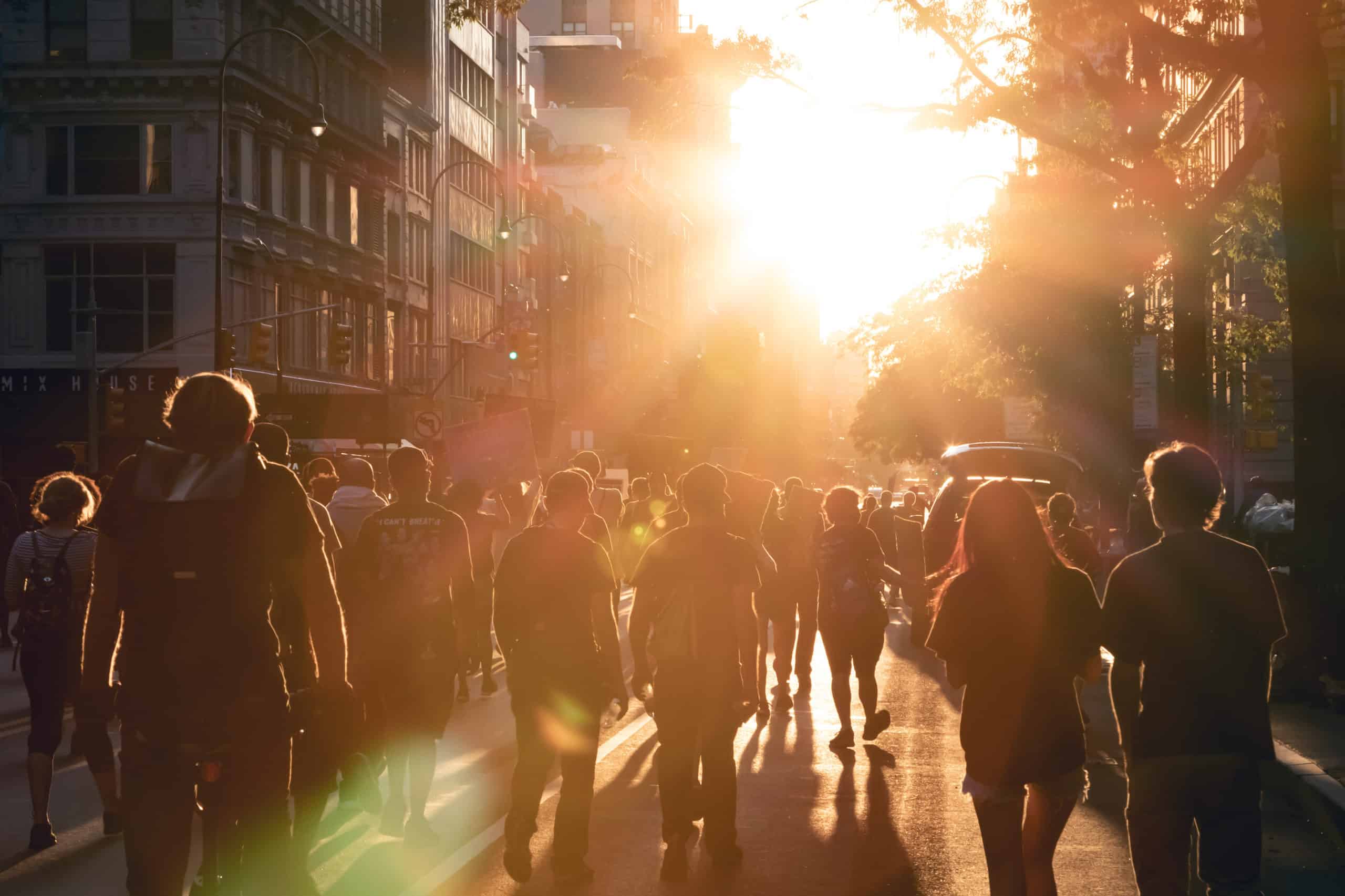 NEW YORK CITY, USA - JUNE 12, 2020: Crowd of people walk into the light of sunset at a peaceful protest march on 14th Street in Manhattan.