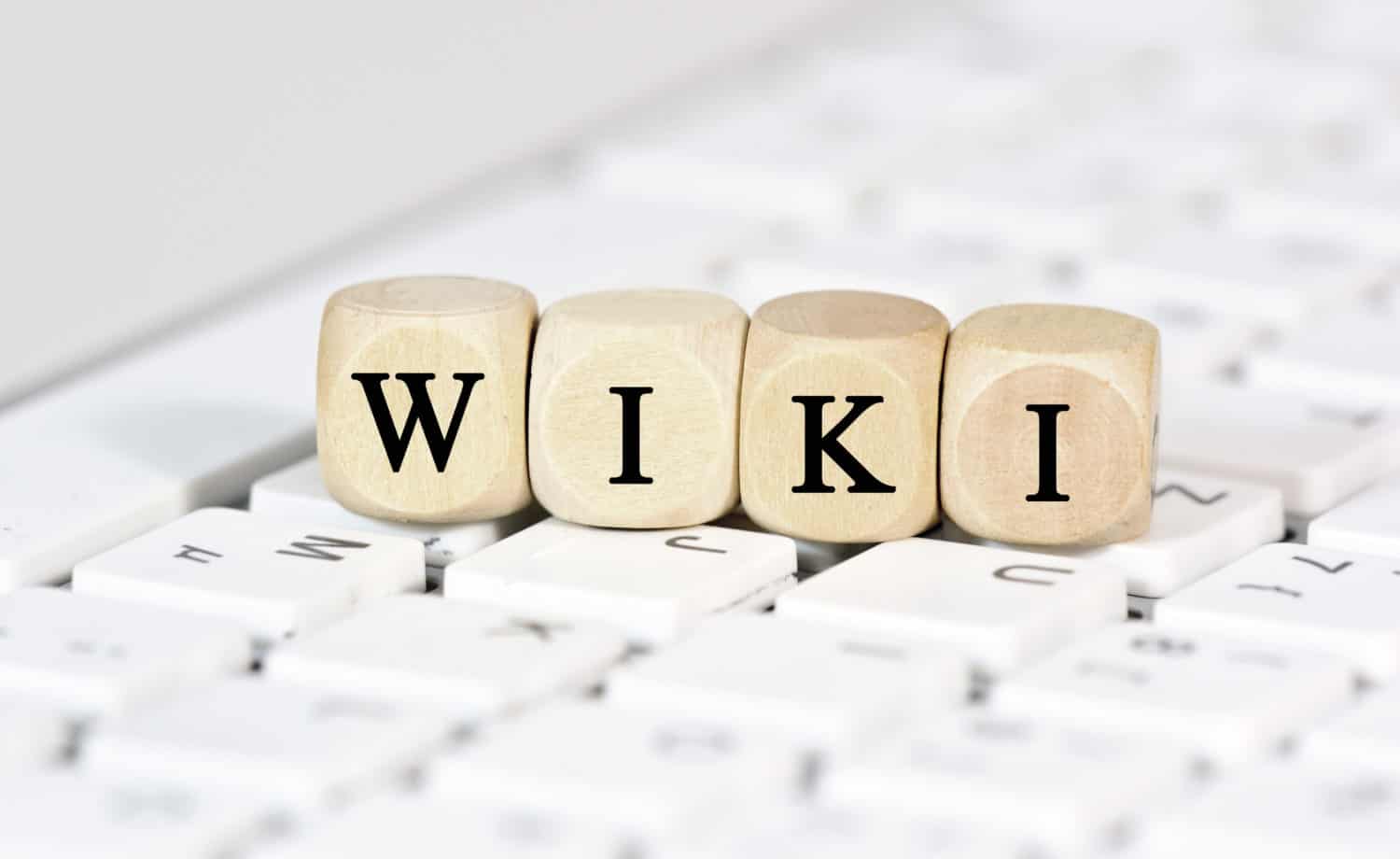 Blocks with letters spell out "wiki," resting on a keyboard