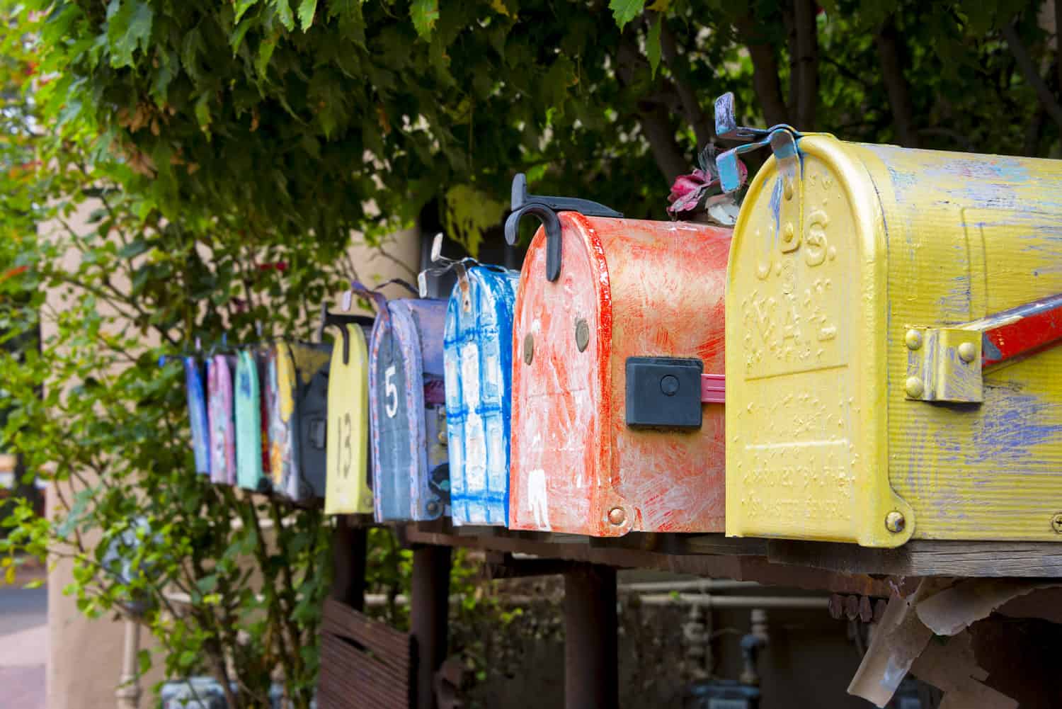 A row of colorful, decorated mailboxes