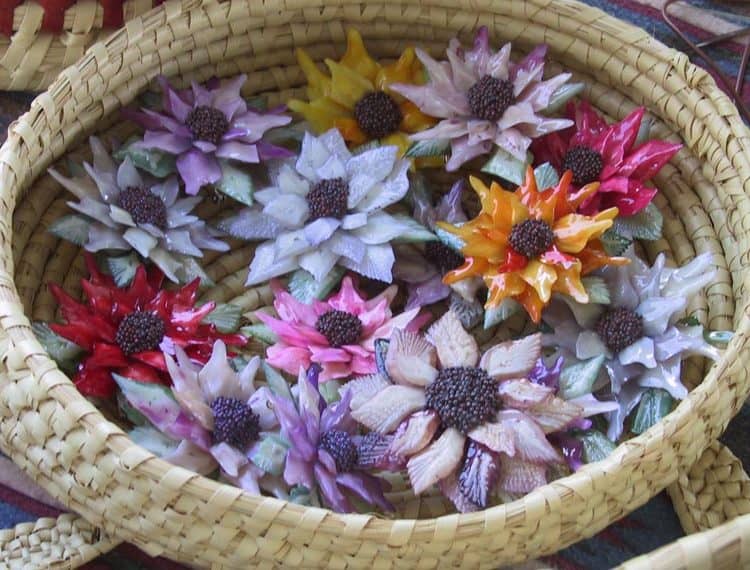 Small, colorful, flower head sculptures made from garfish scales.