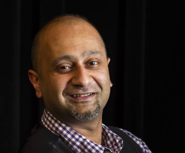 A headshot of a man smiling towards the camera.