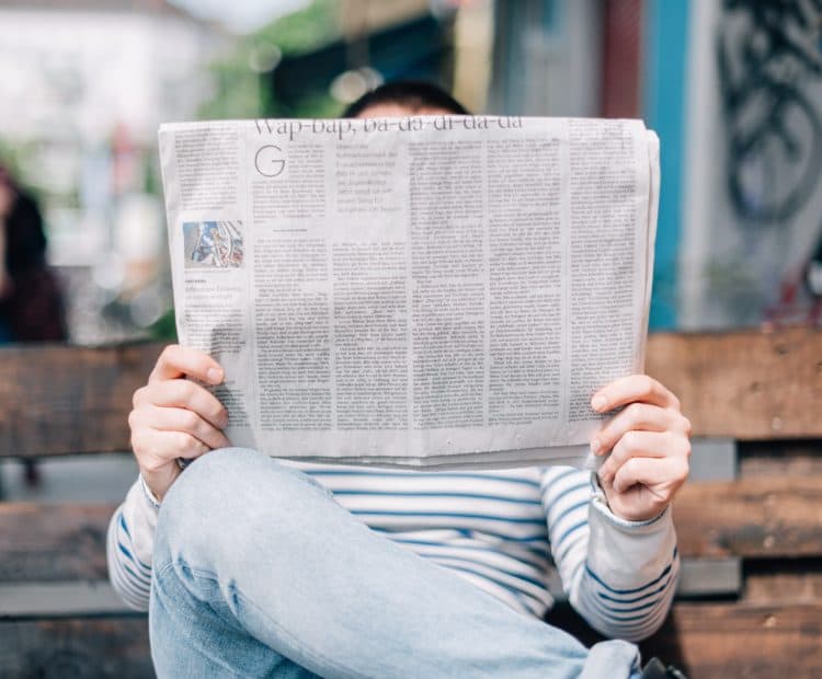 Person reading a newspaper
