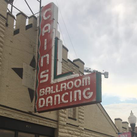A neon sign reading "Cain's Ballroom Dancing"