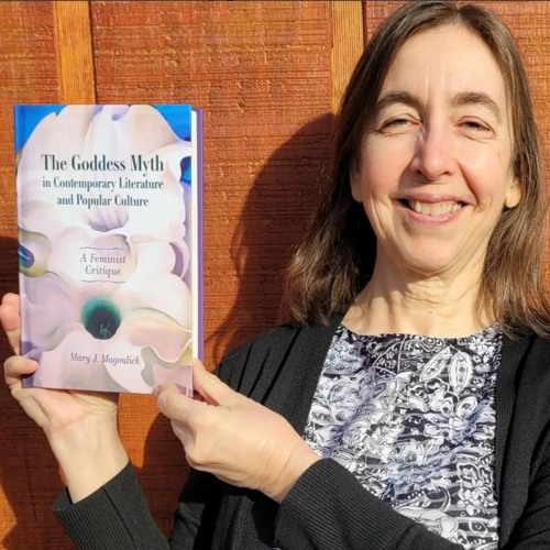 mary magoulick smiling and holding the book for which they received honorable mention for this prize