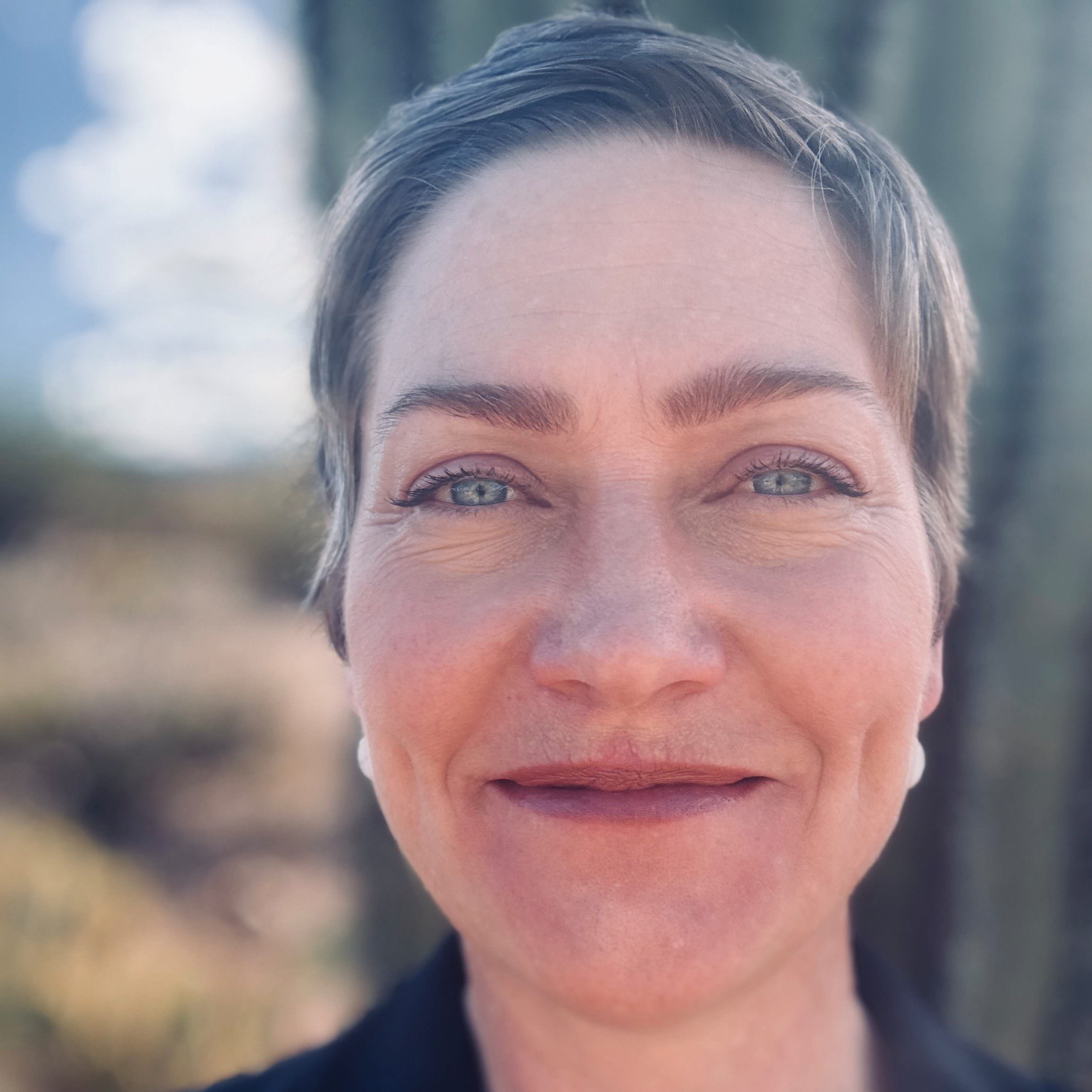 Headshot of Leia Maahs, who is a white woman with short blonde hair and blue eyes and is wearing a blue blazer.