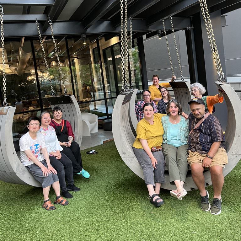 the afs board and staff hanging out in atlanta in a set of concrete swings