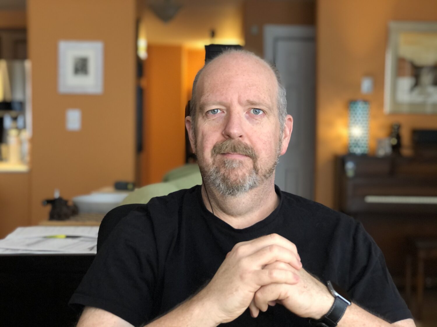 portrait of a white male in black shirt and grey beard