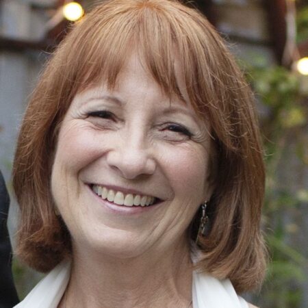 headshot of a smiling white female standing outside