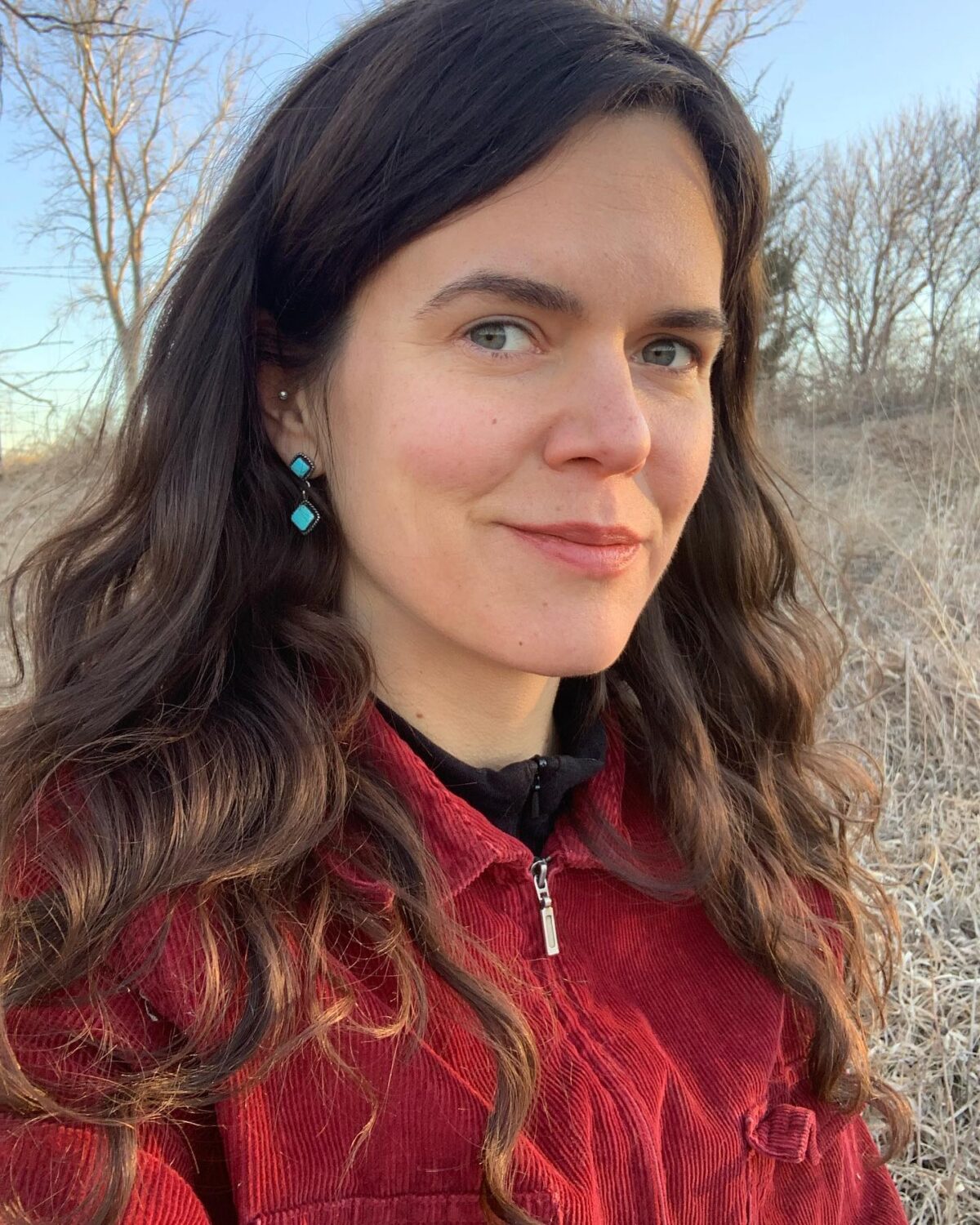 headshot of meagan dion, a woman with long brown hair