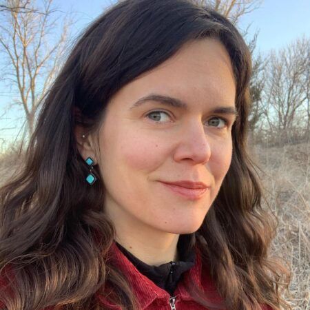 headshot of meagan dion, a woman with long brown hair